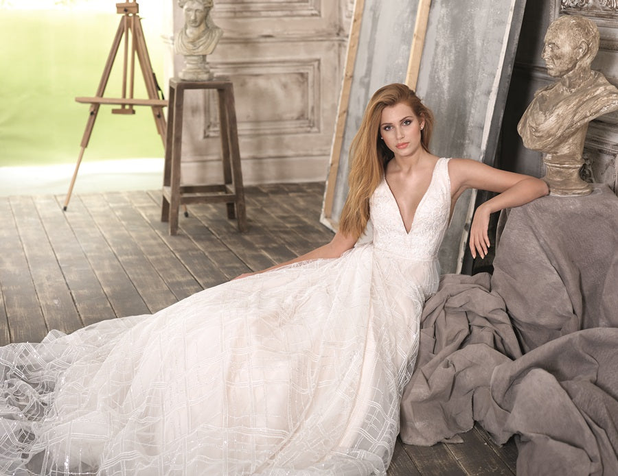 Fara Sposa 5237 is a ballgown with a plunge V neckline. It is made from the most amazing sparkly sequin fabric with champagne tones. This bridal gown is the perfect choice for a modern bride who wants to make a statement. Stunning designer discounted dress amazing quality for cheap sale price.